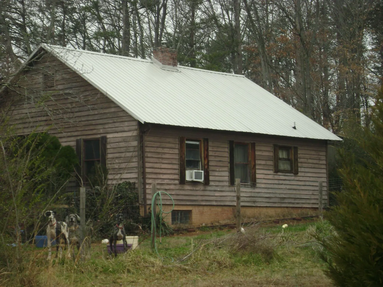 White metal roof on an old wood sided farmhouse, from a Metal Roof Installation job in Fulton